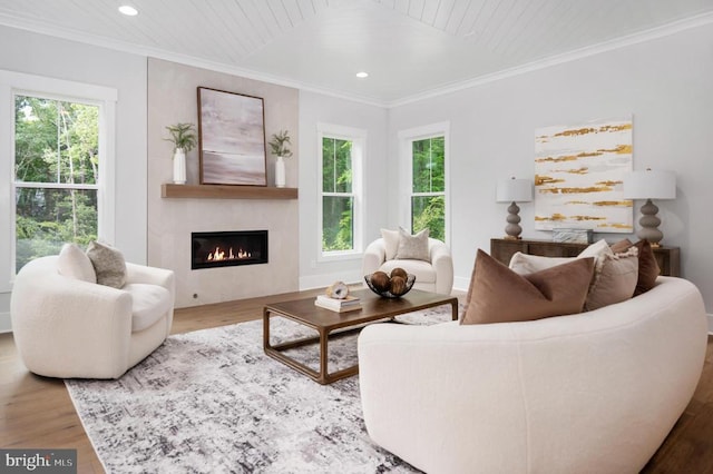 living room featuring a healthy amount of sunlight, crown molding, wood finished floors, and recessed lighting