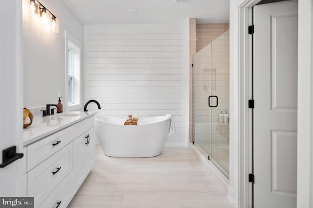 full bathroom featuring visible vents, a stall shower, a freestanding tub, and vanity