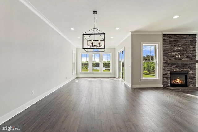 unfurnished living room with plenty of natural light, a fireplace, baseboards, and dark wood finished floors