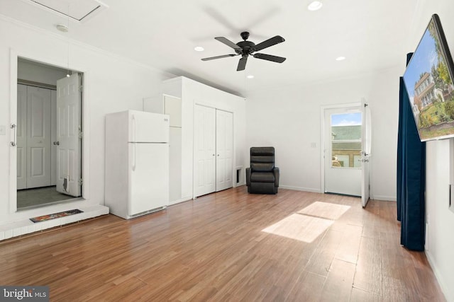 interior space with light hardwood / wood-style flooring, ornamental molding, and ceiling fan