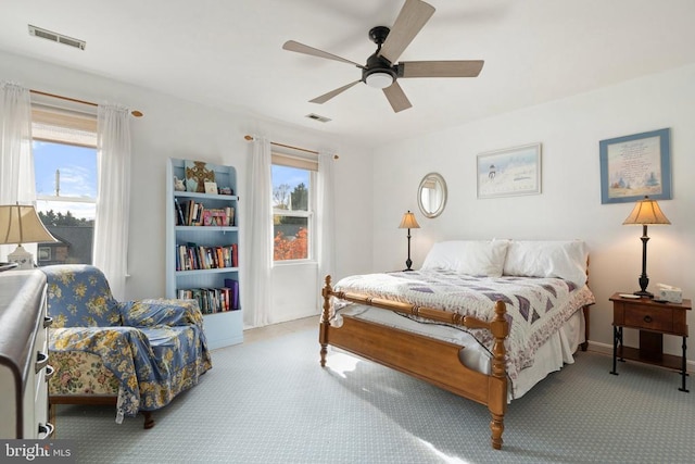 bedroom featuring multiple windows, carpet, and ceiling fan