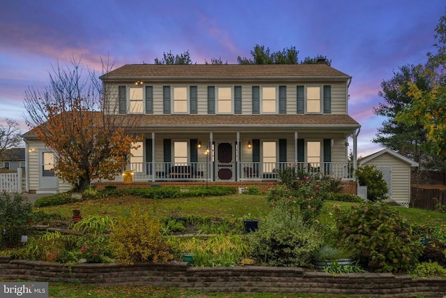 colonial inspired home featuring covered porch