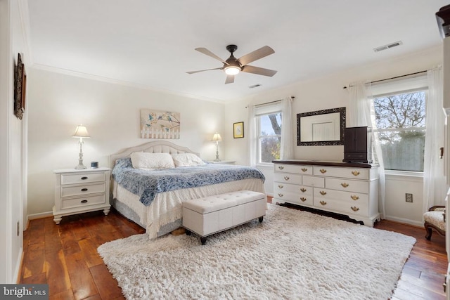 bedroom with crown molding, ceiling fan, and dark hardwood / wood-style floors