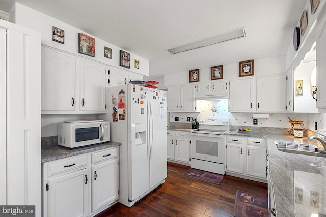 kitchen featuring sink, white appliances, white cabinetry, light stone counters, and dark hardwood / wood-style flooring