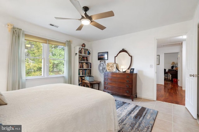 bedroom with light tile patterned floors and ceiling fan