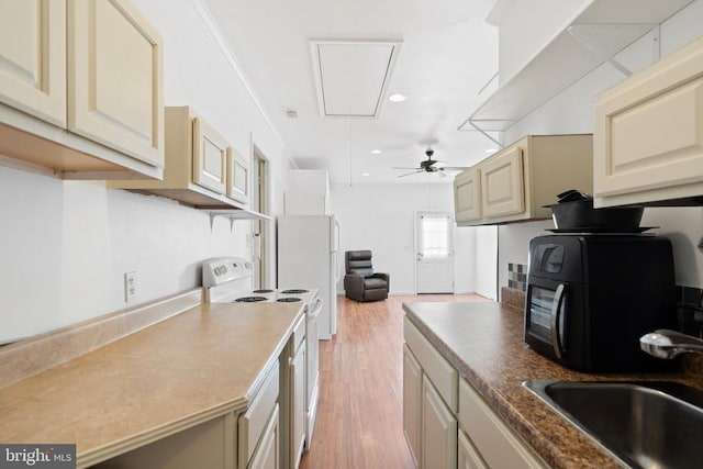 kitchen with cream cabinets, sink, white electric stove, ceiling fan, and light hardwood / wood-style floors