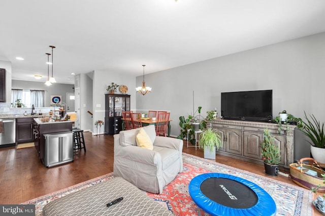 living room featuring a chandelier, dark wood-style flooring, and recessed lighting