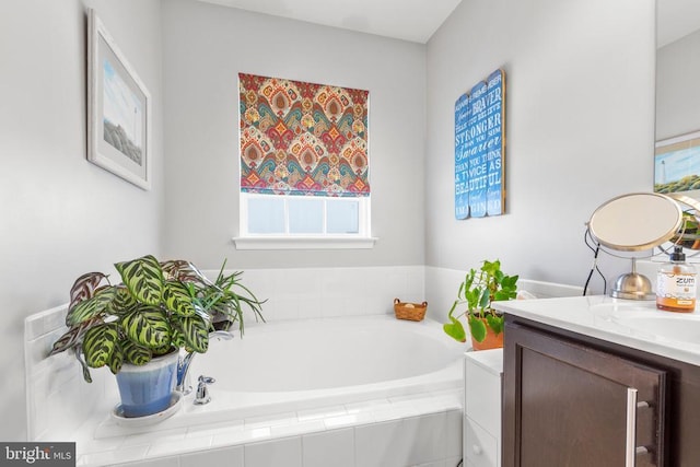 full bathroom featuring a garden tub and vanity