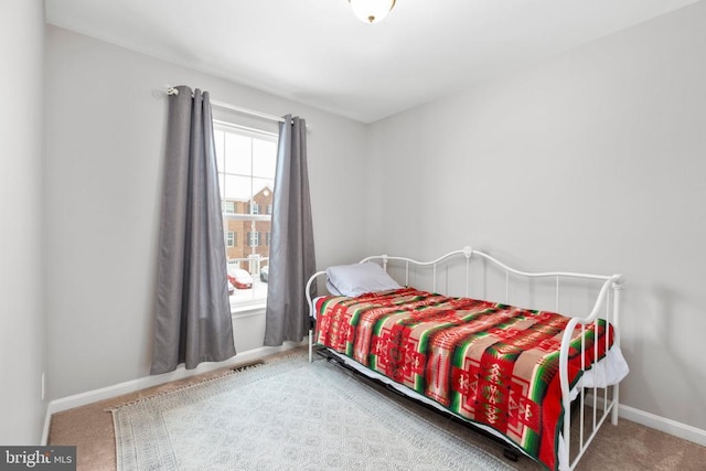 carpeted bedroom with visible vents and baseboards