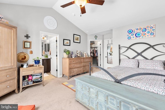 bedroom with a walk in closet, lofted ceiling, a closet, a ceiling fan, and light carpet