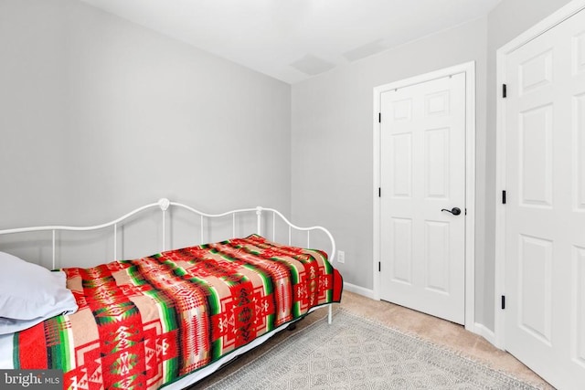 bedroom with light carpet and baseboards