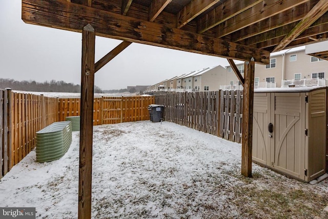 yard covered in snow with a fenced backyard