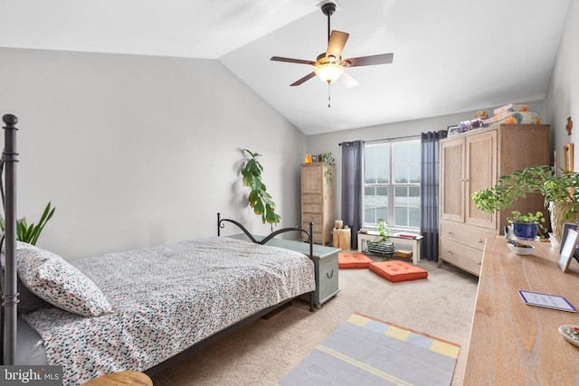 bedroom featuring lofted ceiling, a ceiling fan, and light colored carpet