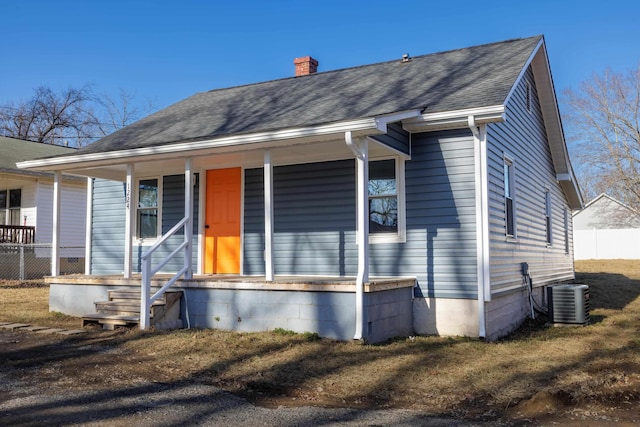 bungalow-style house featuring central AC unit and a porch