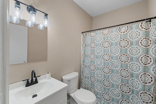 bathroom featuring vanity, curtained shower, and toilet