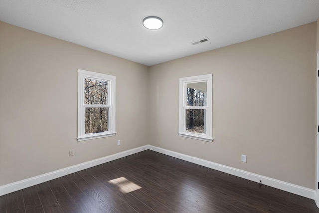 spare room with dark hardwood / wood-style floors