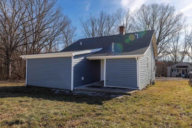 rear view of property featuring a yard