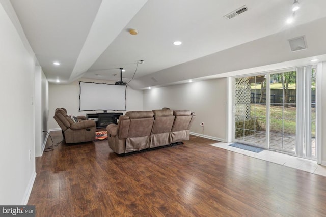 living room with baseboards, wood finished floors, visible vents, and recessed lighting