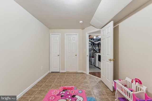 playroom with tile patterned floors, baseboards, and washer / clothes dryer