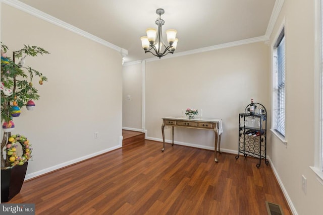 dining space with wood finished floors, visible vents, a chandelier, and crown molding