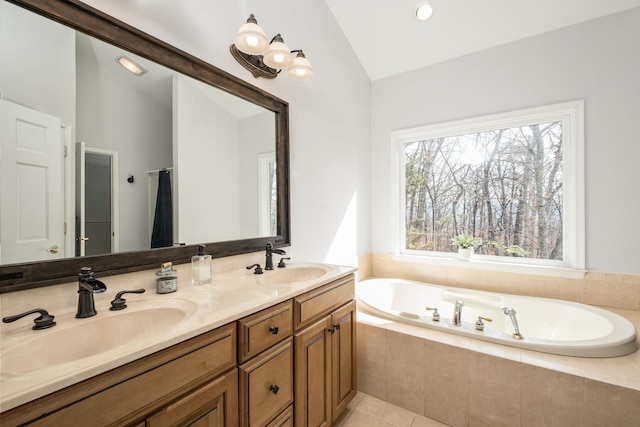 bathroom with vaulted ceiling, a wealth of natural light, and a sink