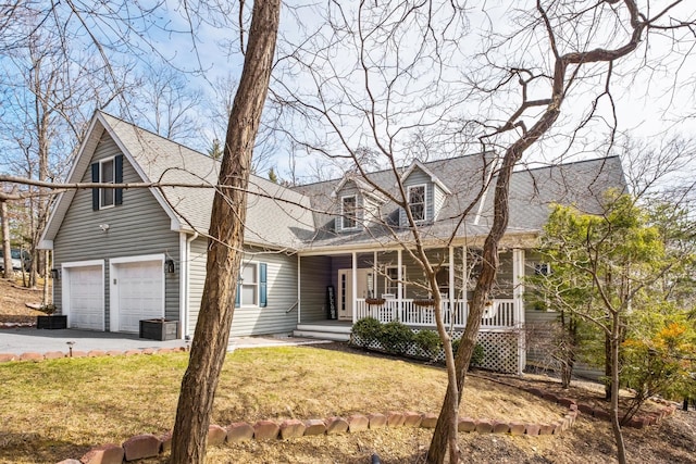 cape cod-style house featuring a front lawn, aphalt driveway, a porch, a shingled roof, and a garage