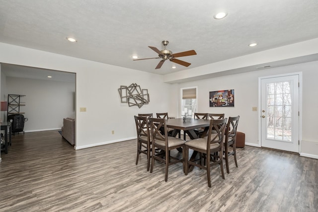 dining space with recessed lighting, baseboards, and wood finished floors