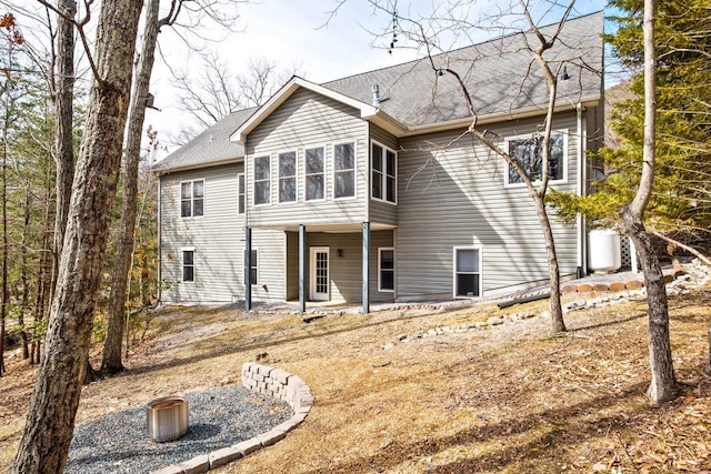 back of property featuring a shingled roof