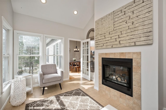 sitting room with tile patterned flooring, baseboards, a tiled fireplace, vaulted ceiling, and recessed lighting