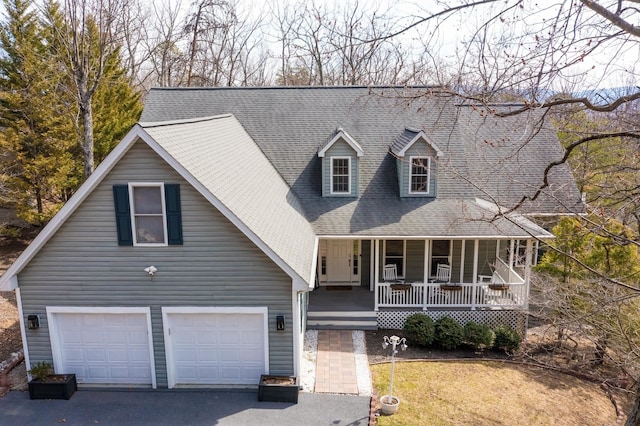 view of front facade featuring a porch, an attached garage, driveway, and roof with shingles