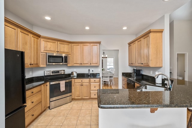 kitchen with light tile patterned floors, recessed lighting, a peninsula, black appliances, and a sink