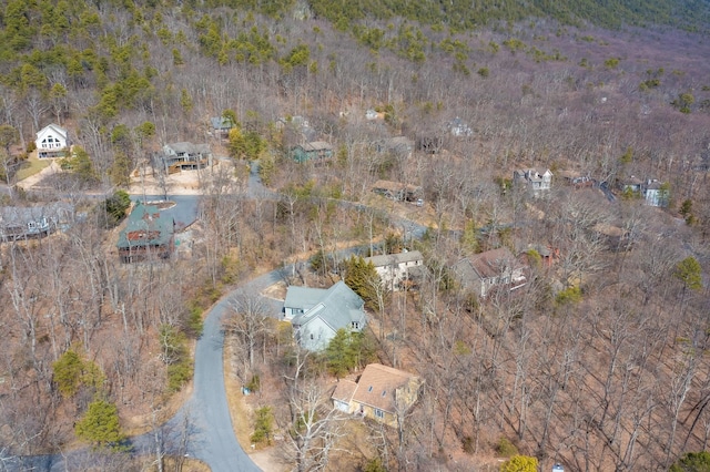 birds eye view of property featuring a view of trees