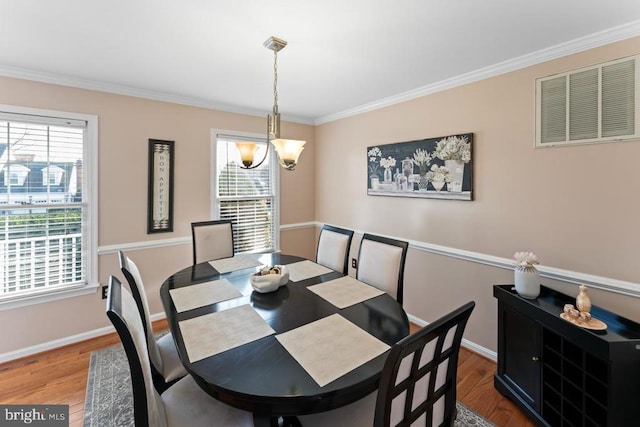 dining space featuring plenty of natural light, wood finished floors, and visible vents