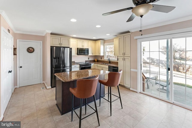 kitchen with stainless steel microwave, black fridge with ice dispenser, cream cabinets, and range with electric stovetop