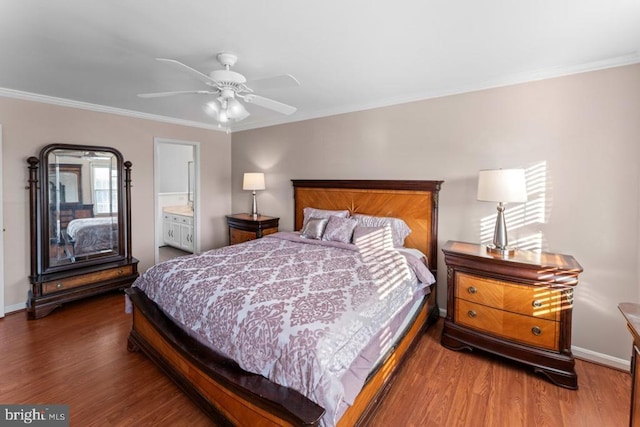 bedroom featuring crown molding, baseboards, and wood finished floors