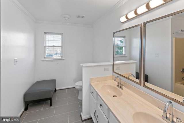 bathroom featuring a sink, visible vents, and crown molding