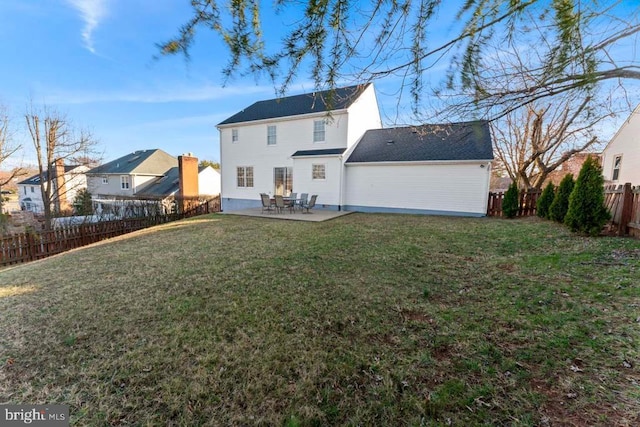 back of property featuring a yard, a patio area, and a fenced backyard