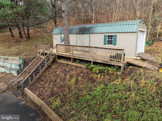 deck featuring stairs and a garage