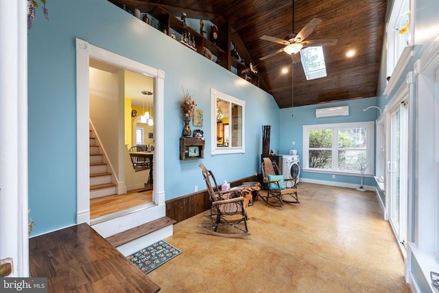 living area featuring an AC wall unit, a skylight, a ceiling fan, wood ceiling, and high vaulted ceiling