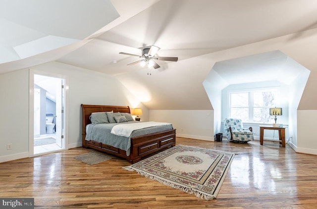 bedroom with lofted ceiling, baseboards, and wood finished floors