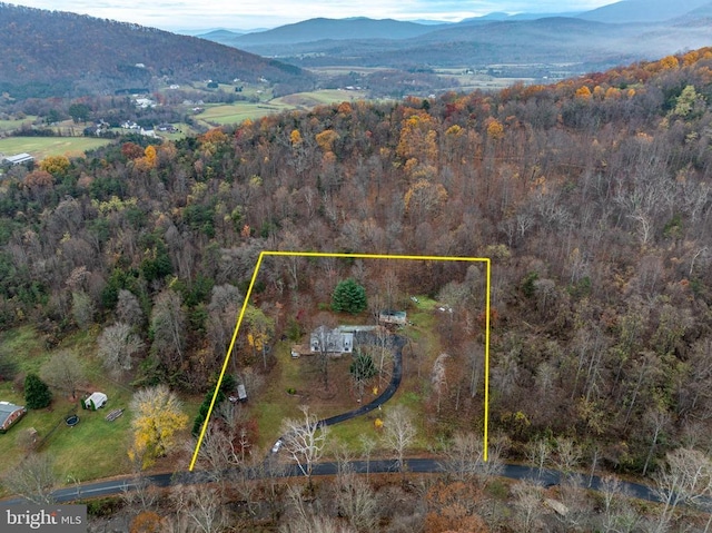 aerial view featuring a forest view and a mountain view