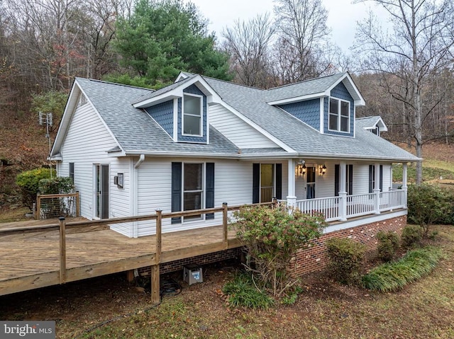 view of front of property with a shingled roof and covered porch