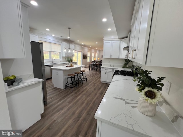 kitchen featuring a sink, a center island, dark wood finished floors, white cabinetry, and stainless steel dishwasher