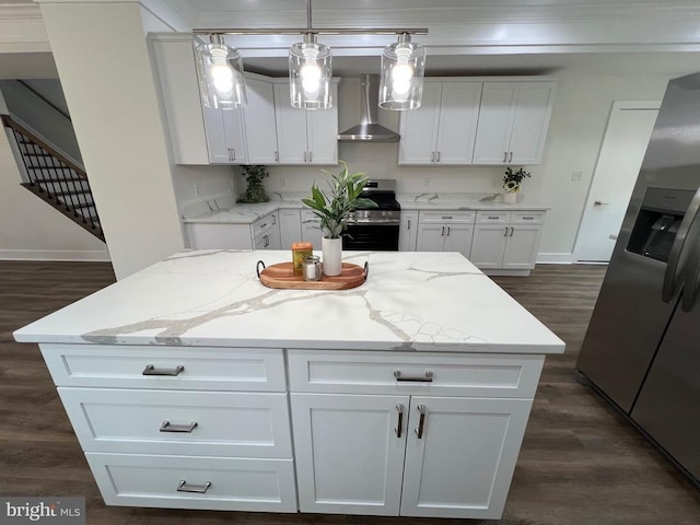 kitchen with appliances with stainless steel finishes, white cabinetry, and wall chimney range hood