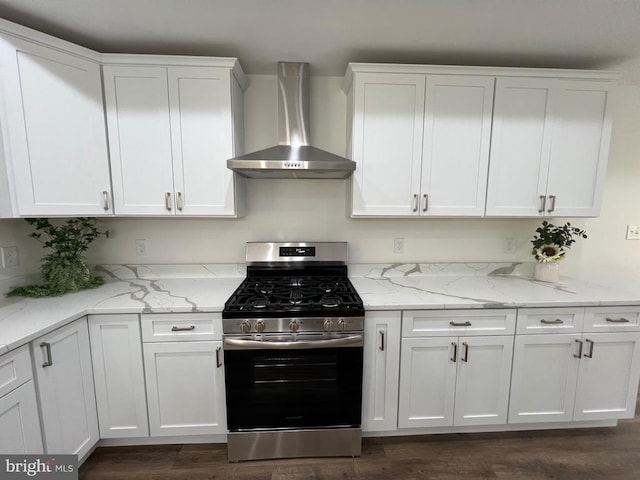 kitchen featuring gas stove, light stone countertops, dark wood-type flooring, white cabinetry, and wall chimney exhaust hood