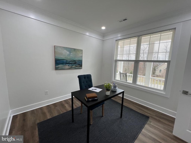 office featuring dark wood-type flooring, baseboards, visible vents, and ornamental molding