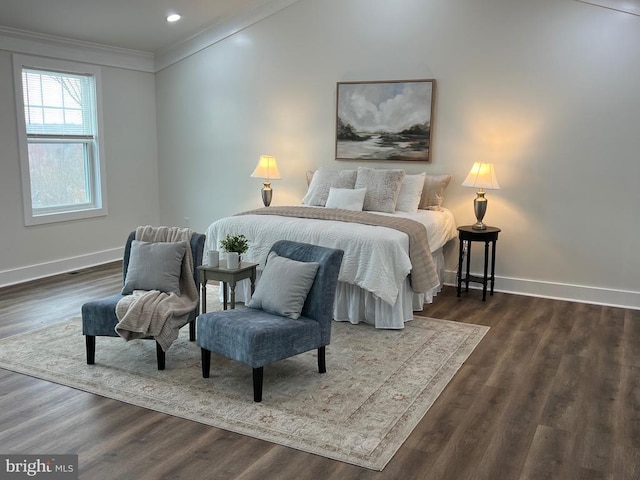 bedroom with wood finished floors, baseboards, and ornamental molding