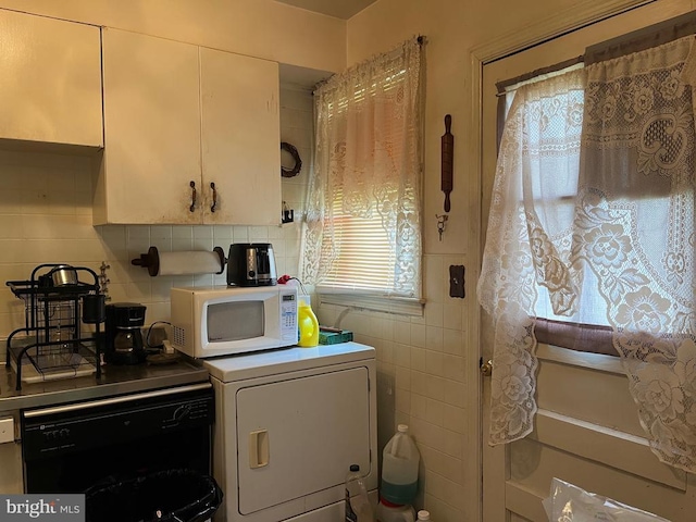 laundry room featuring laundry area and tile walls