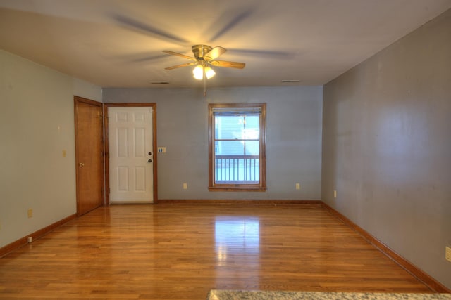 spare room with light hardwood / wood-style flooring and ceiling fan