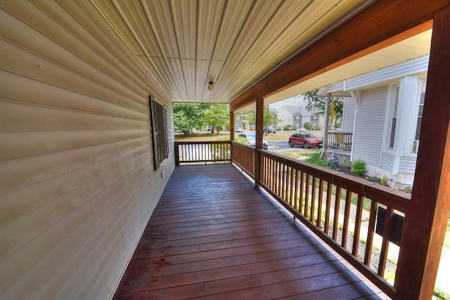 wooden terrace featuring covered porch